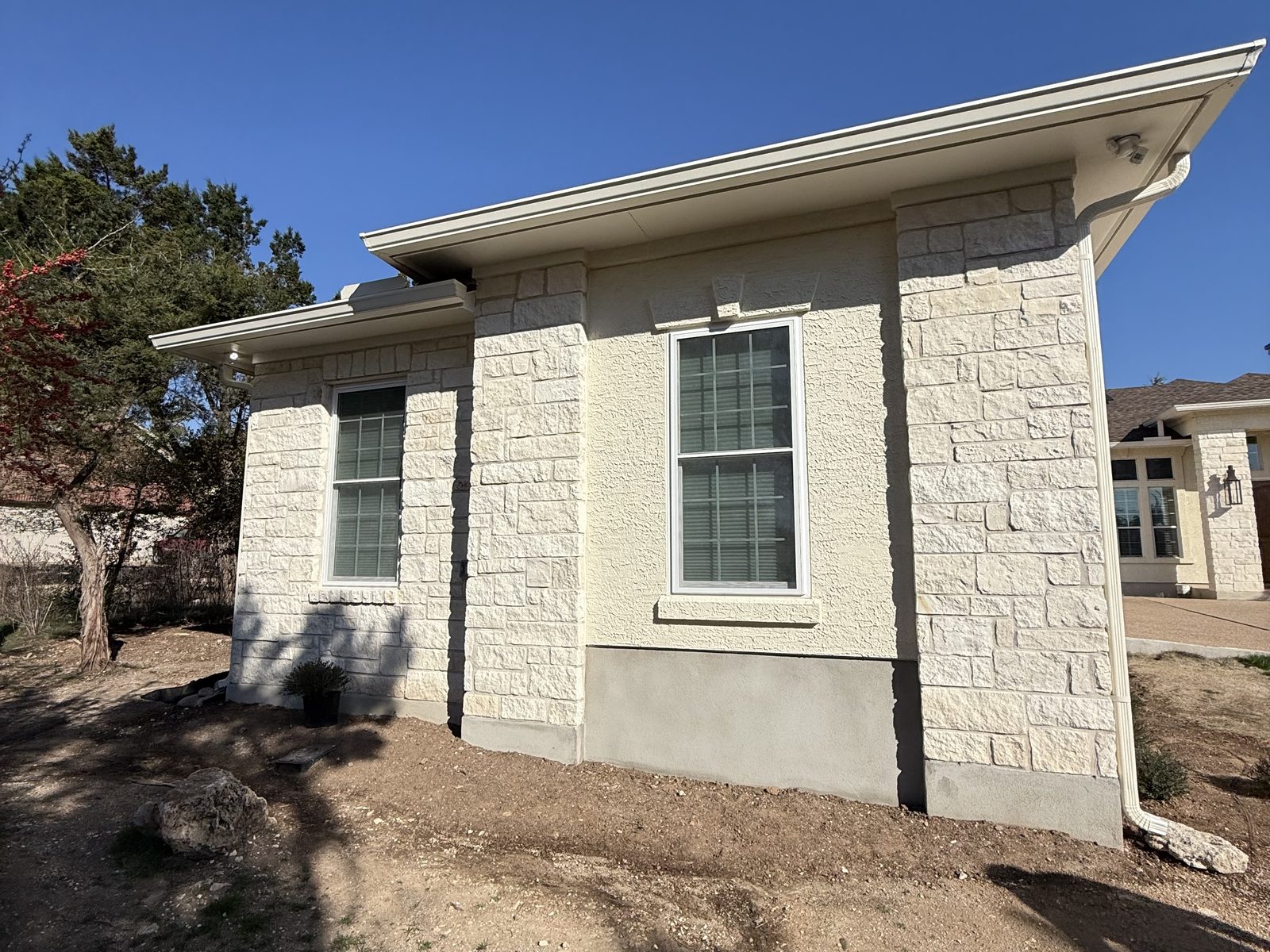 New limestone home addition exterior in Austin under a clear sky